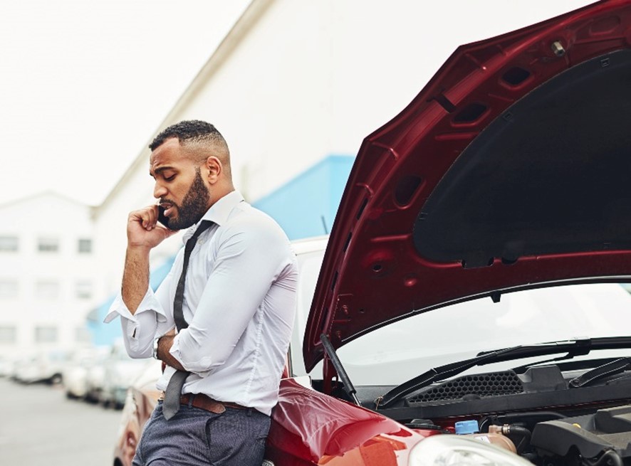 A man on the phone with his insurance after a car accident