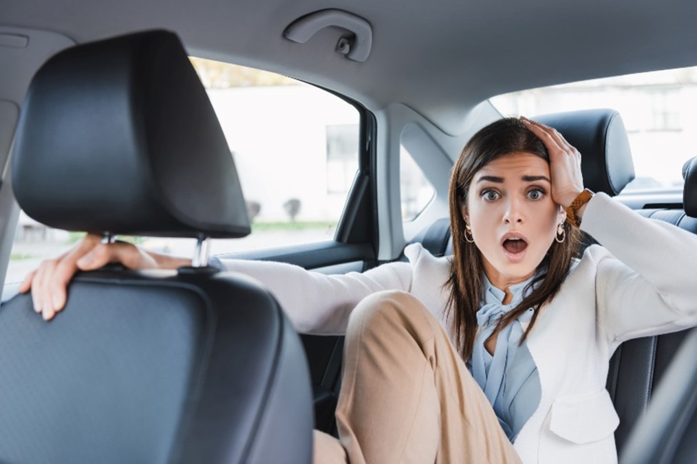 Woman holding her head after an accident in a car