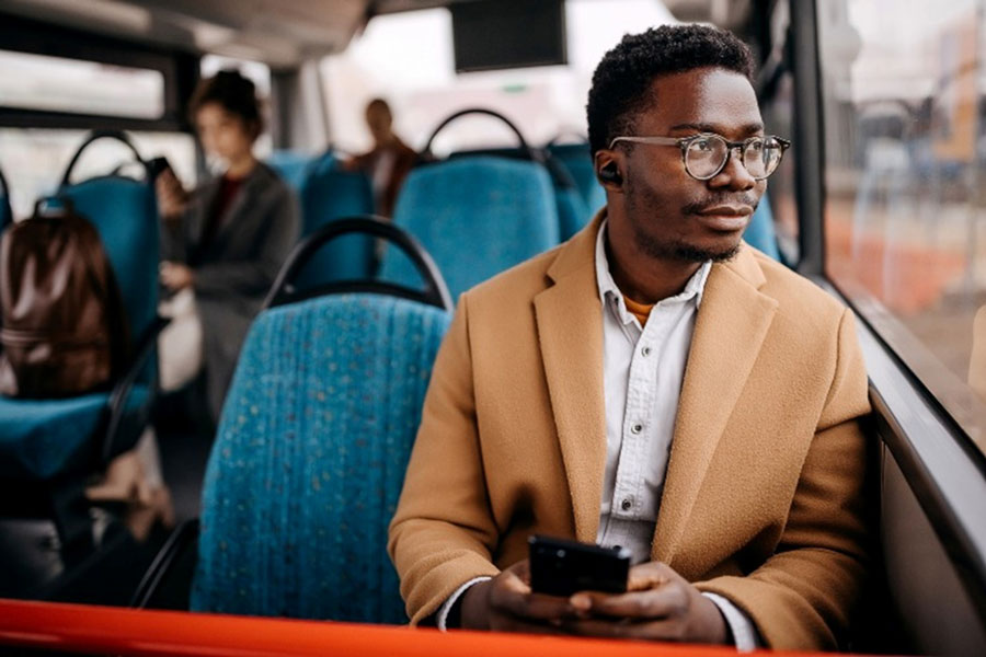 Young businessman is enjoin his bus ride