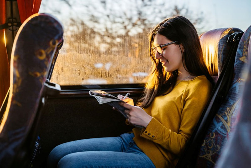 Young women is enjoing a scenic bus ride